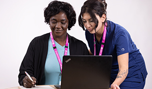 Two BCNU members looking at a laptop