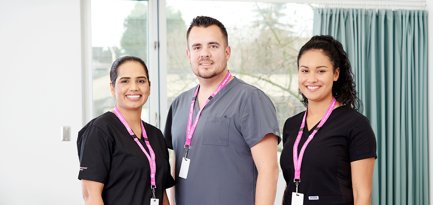 Three diverse BCNU members standing in hospital room