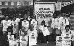 Black and white photo of BCNU members wearing placards