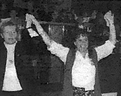 Black and white photo of two members holding hands raises in the air