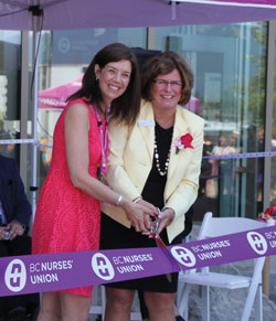 Christine Sorensen and Gayle Duteil cutting the ribbon at the new education centre opening