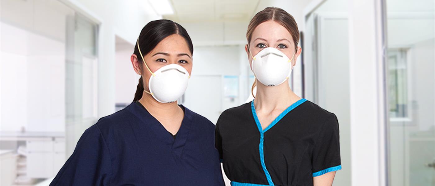 Two BCNU members wearing masks standing in a hallway