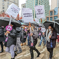 BCNU members marching in a rally with signs