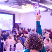 BCNU member holding up their badge at convention