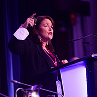 Linda Silas speaking at the podium