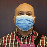 Portrait of Neil Penalosa wearing a surgical mask