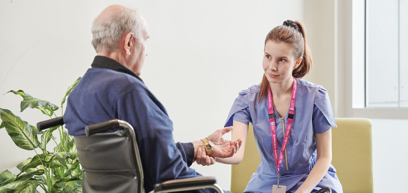 Nurse tending to senior in wheel chair