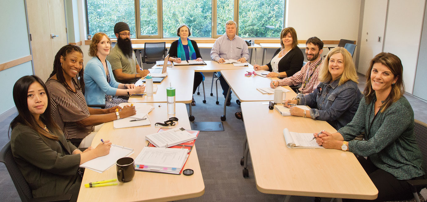 Group of BCNU representatives seated around the table at the union's head office 