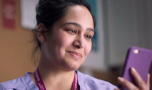 A nurse checks her phone