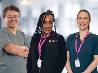 A picture of three nurses standing facing the camera