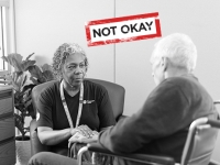 Nurse with elderly patient. Text saying "Not Okay" between them