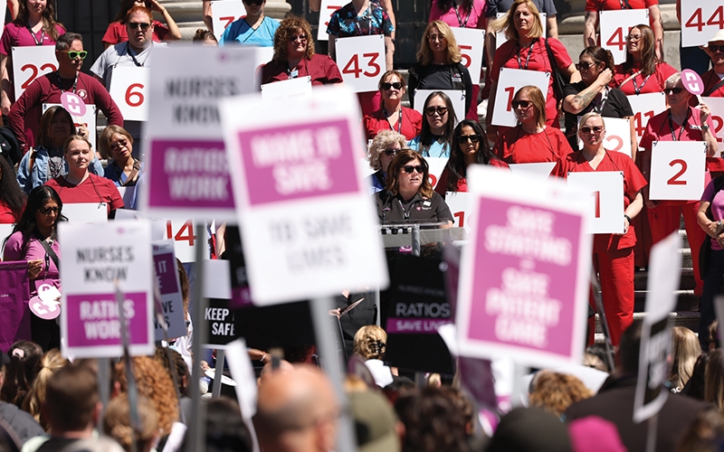BCNU President Adriane Gear stands with members representing the 46 nurses on average who file WorkSafeBC time-loss injury claims each month. 