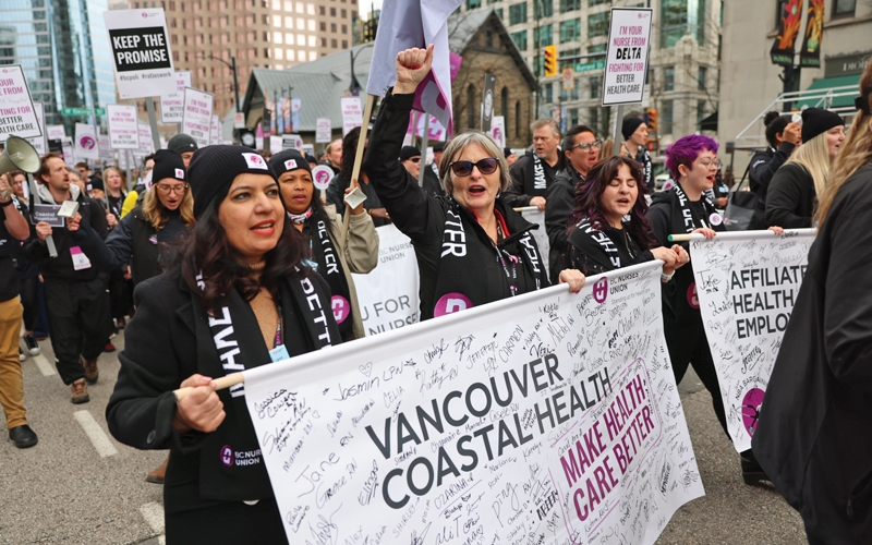 Members who work for Vancouver Coastal Health march in the rally. 