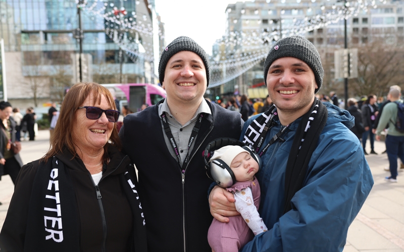 Nurses Ben Woywitka, Mike Woywitka, and Kelly Woywitka with possible future nurse Izzy Woywitka at the rally on day two.