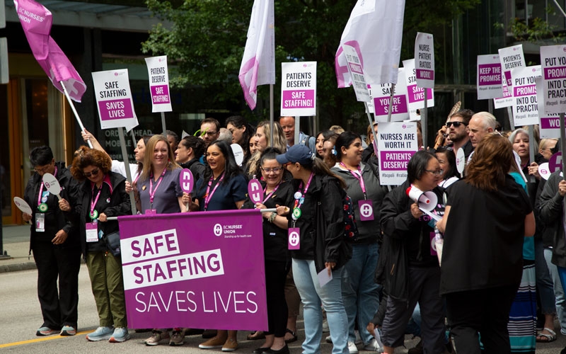 Provincial executive committee members lead the union’s march along West Georgia Street in downtown Vancouver