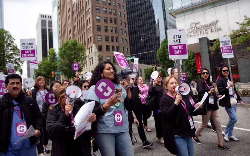 Members march down Burrard Street to raise awareness of the nurse staffing crisis.