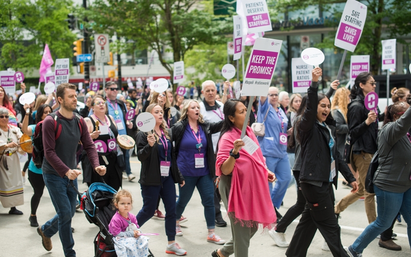 Members march down Burrard Street to raise awareness of the nurse staffing crisis.