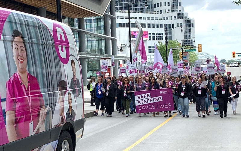 BCNU campaign vehicle leads members in march through downtown Vancouver.