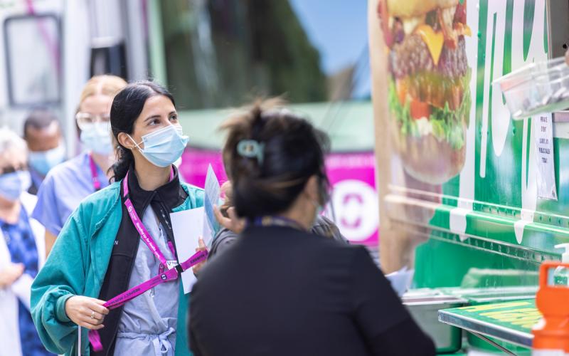 Members queue for their lunch at the White Spot food truck.