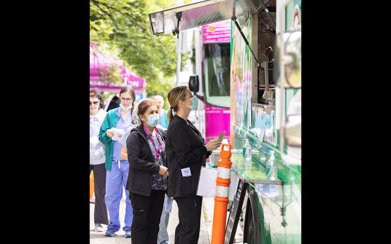 Members queue for their lunch at the White Spot food truck.